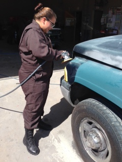 Student prepping a vehicle to paint