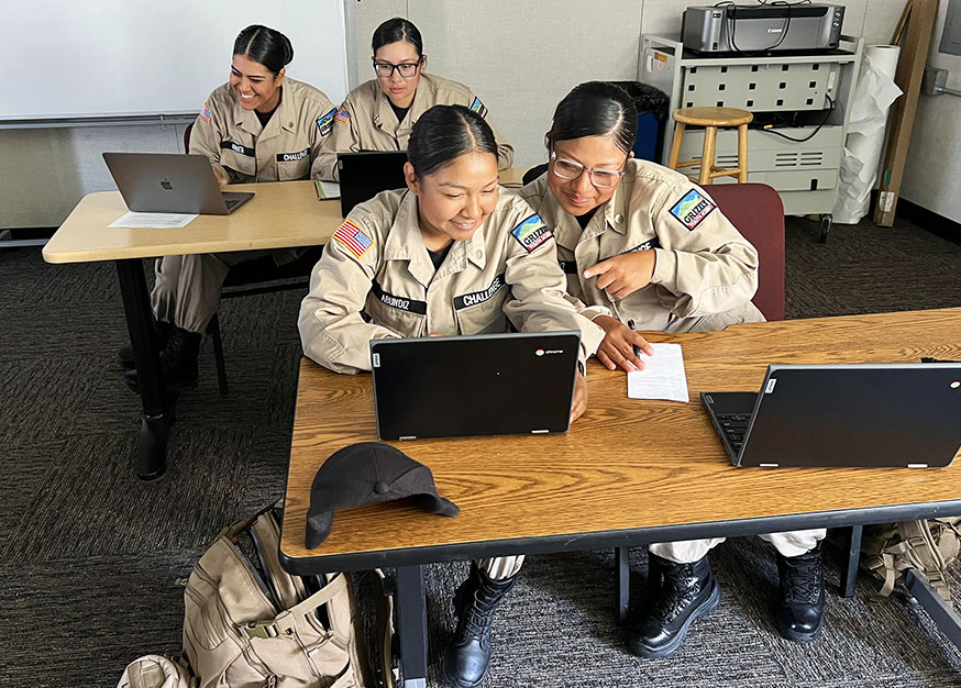 Two students studying on a laptop